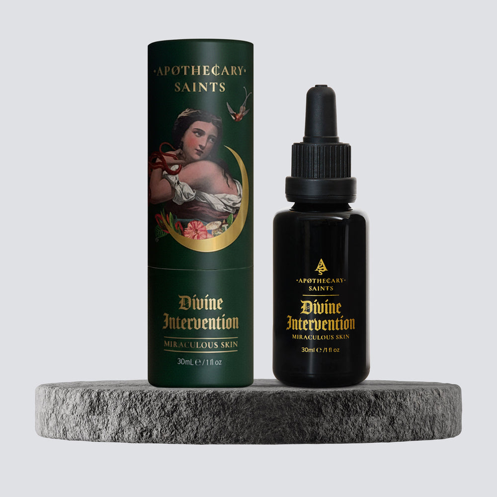 divine intervention face oil packaging on grey stone