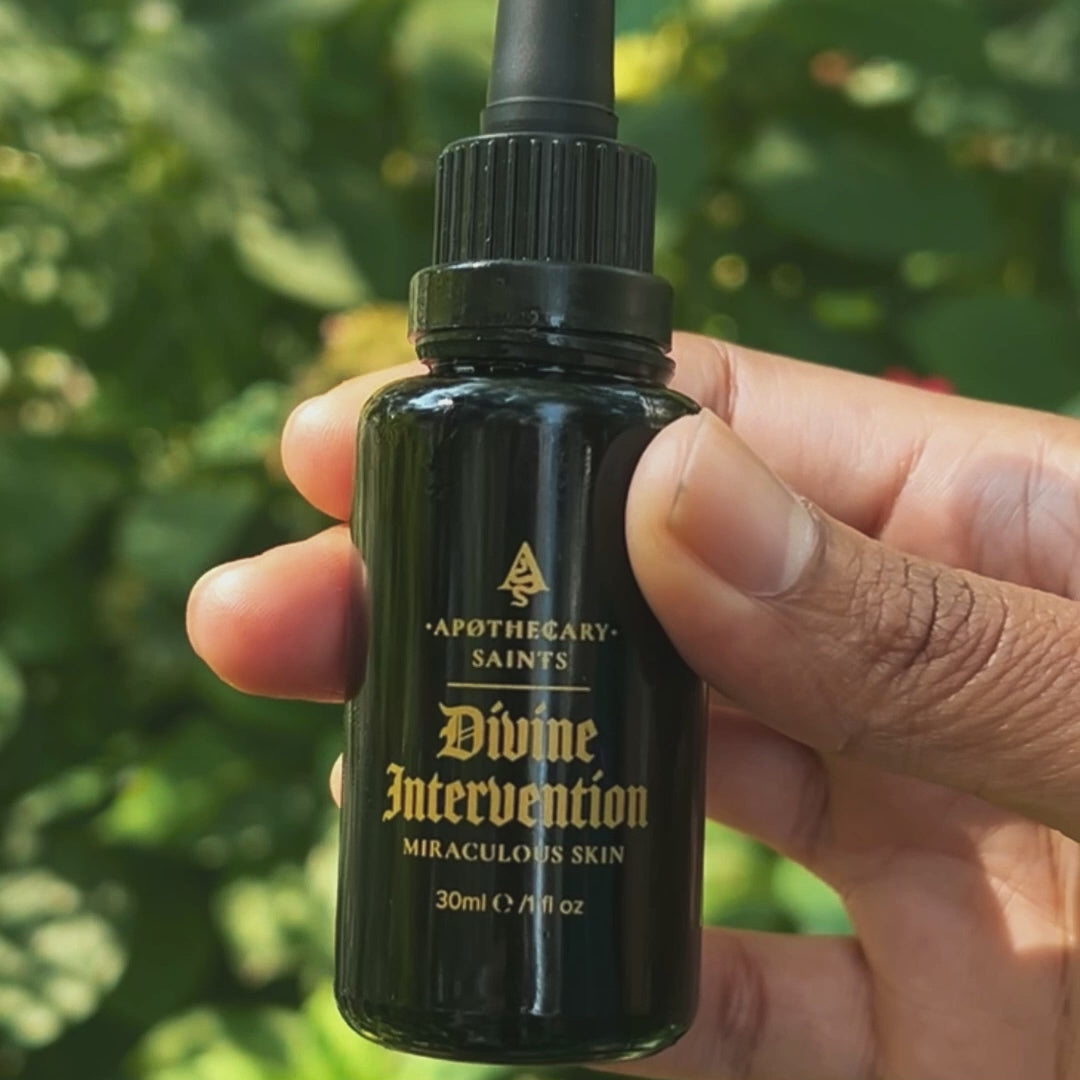 hand holding divine intervention and dripping face oil oil into hand